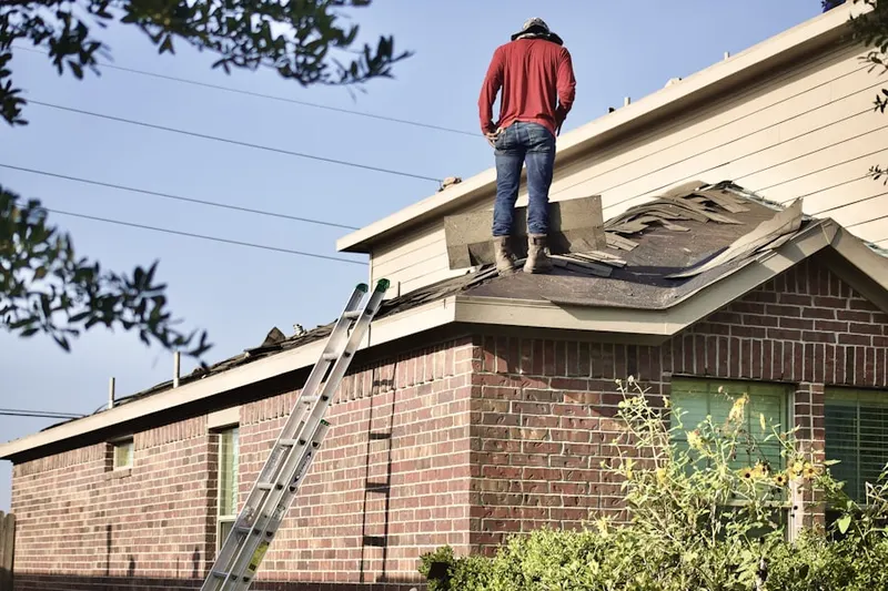 Professional roofer working on a residential roof in Schalks